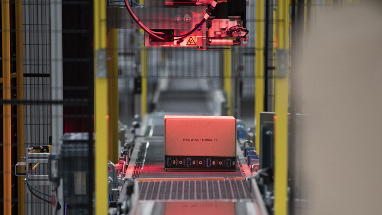 A box moving on a conveyer belt inside an Amazon fulfillment centre.