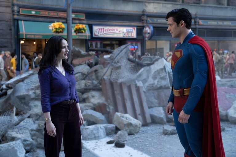 Superman talking to a woman amid city rubble