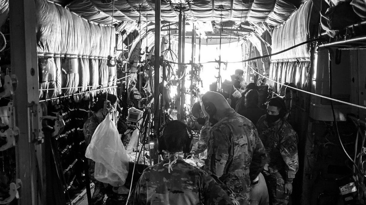 An image of Dr. Gupta's work on a military plane to support COVID-19 relief efforts