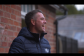 Michael Owen smiles while facing away from the camera 