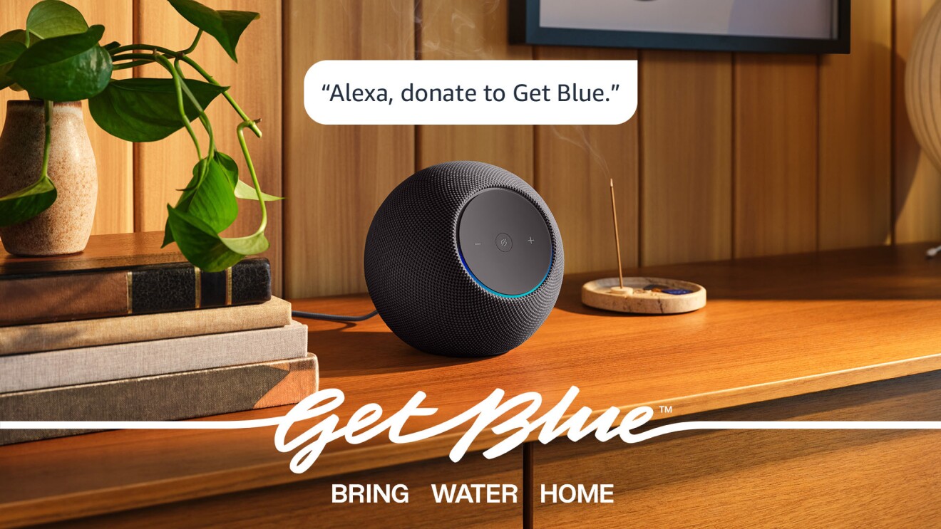 Alexa smart speaker on wooden table with Get Blue branding and tagline 'Bring Water Home'
