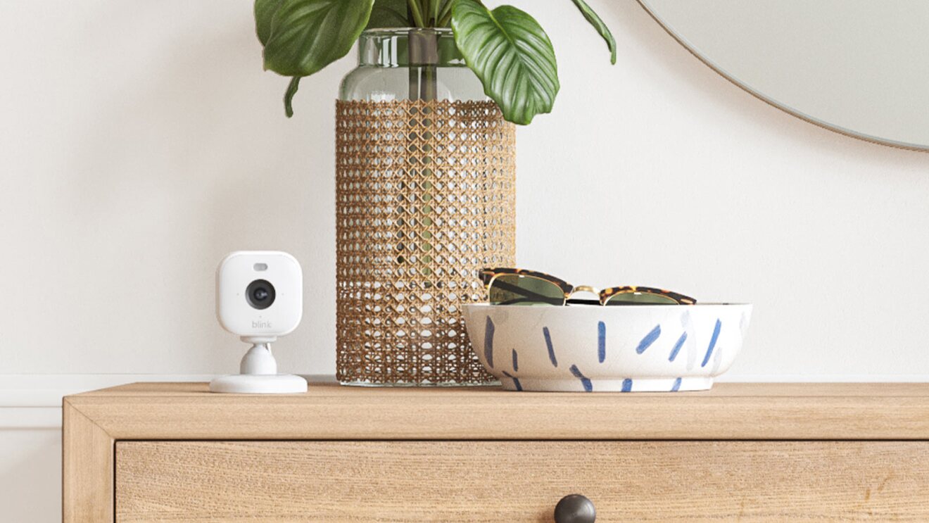 Minimalist home decor with Blink smart camera, woven vase, and sunglasses bowl