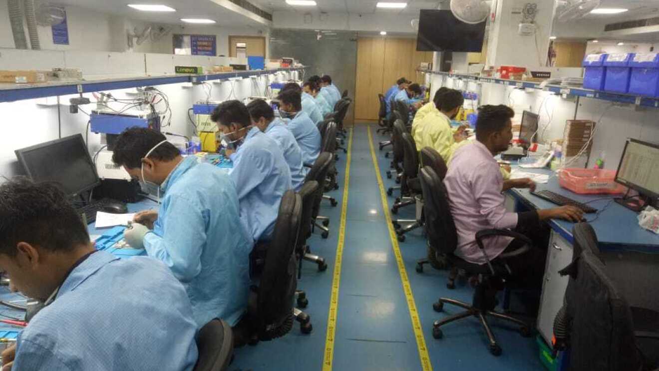 Technicians at work in the Yaantra lab working on refurbished phones