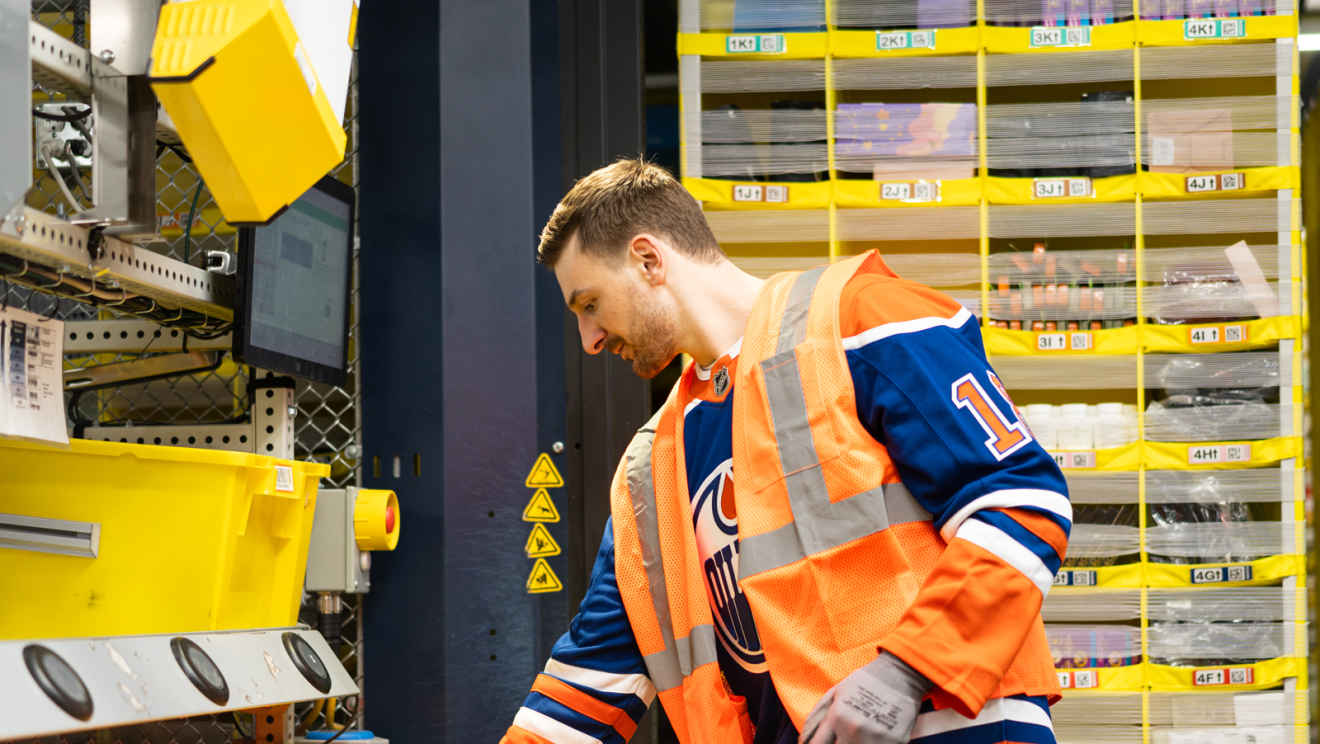 hockey player helping package boxes 