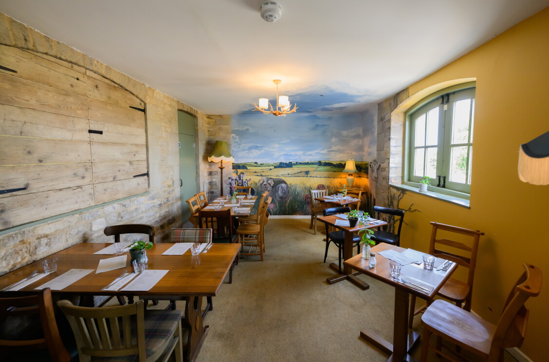 The cosy dining space at The Farmer's Dog in Burford, Jeremy Clarkson's proper British pub from Clarkson's Farm season 4