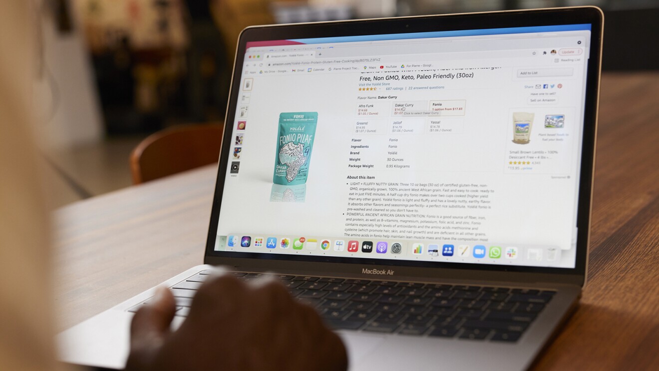 An image of a laptop. On the screen is a product page for "Fonio Pilaf" rice.