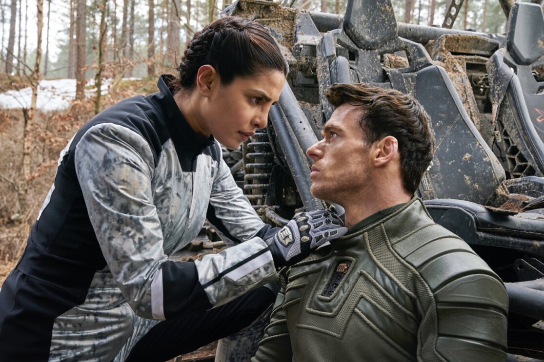 A man and a woman looking at each other with concern in the middle of a woodland area