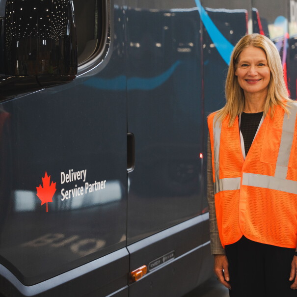 amazon employee standing beside delivery van