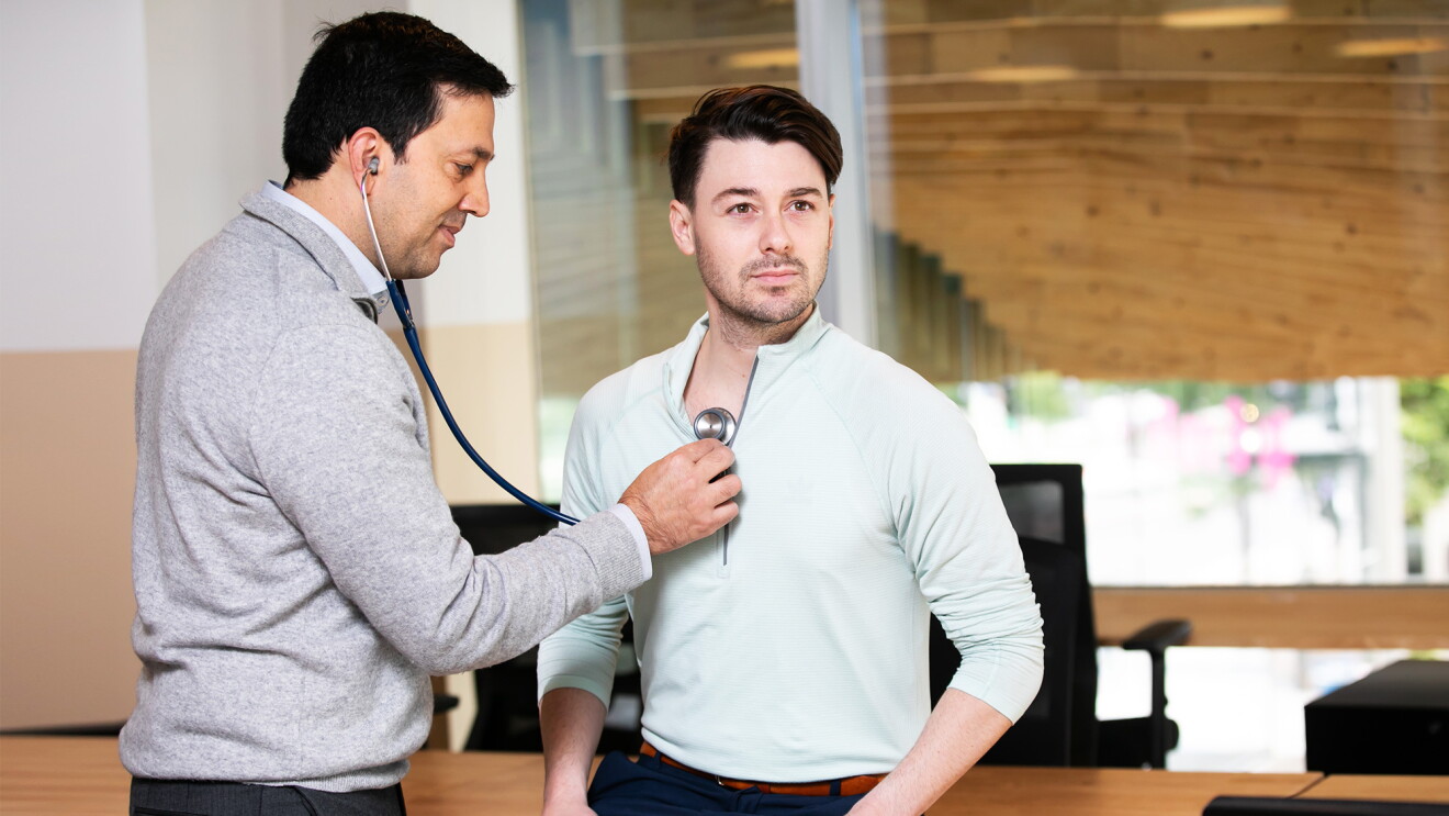 An image of a doctor checking a patient's heartbeat
