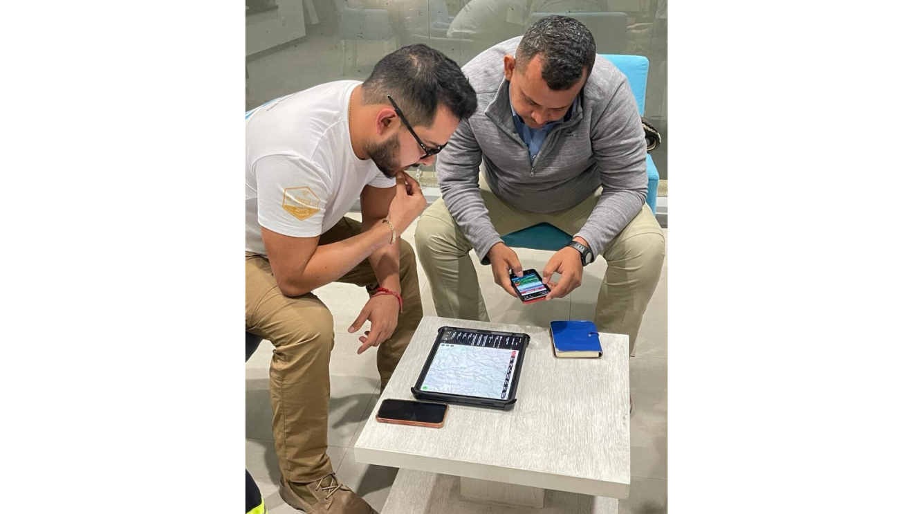 Two men look at AWS technology to support in Chile and Colombia.