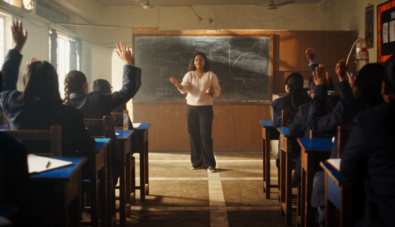 A photo of Vani Agarwal speaking to young women in a classroom.