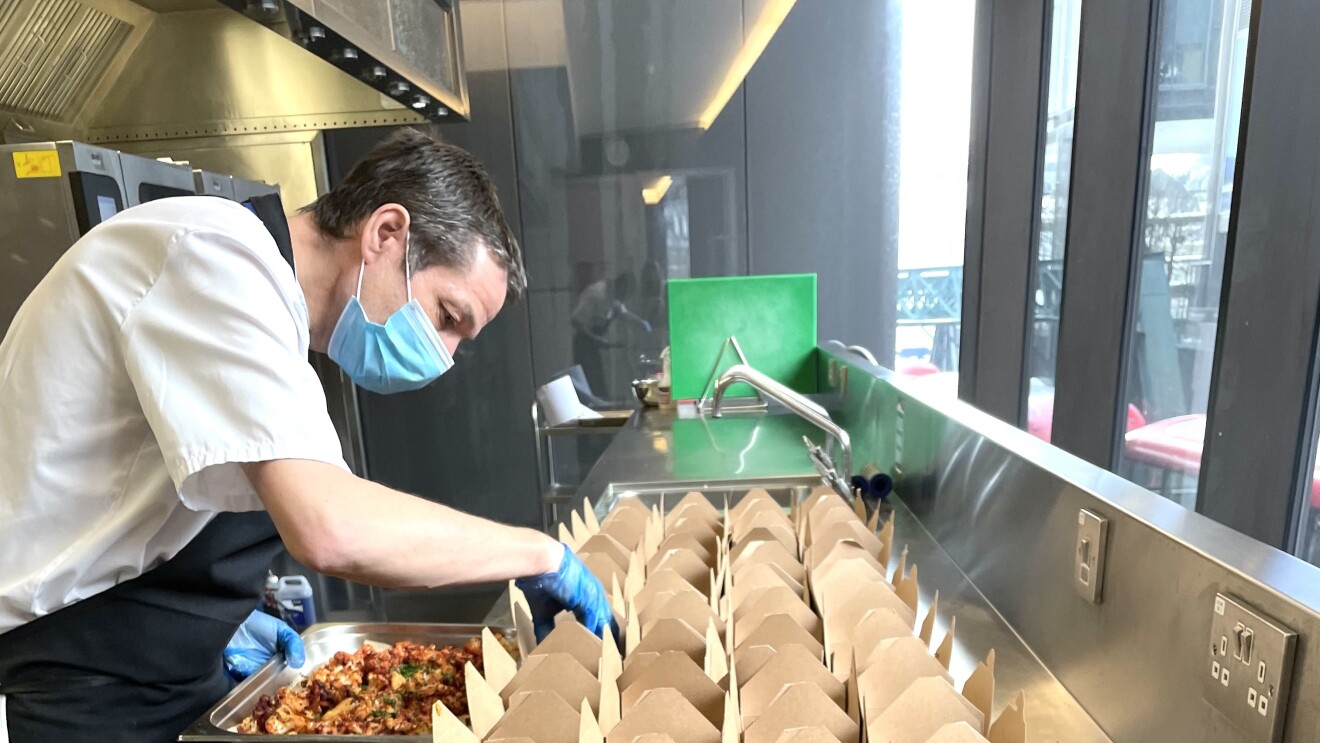 Alex Borley from BaxterStorey packing food boxes to donate to the local Shoreditch community.