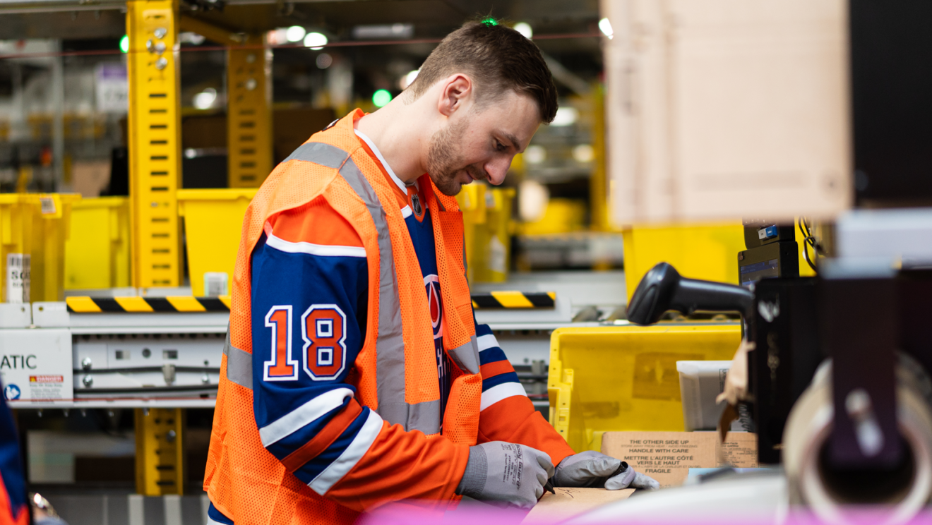 hockey player helping package boxes 