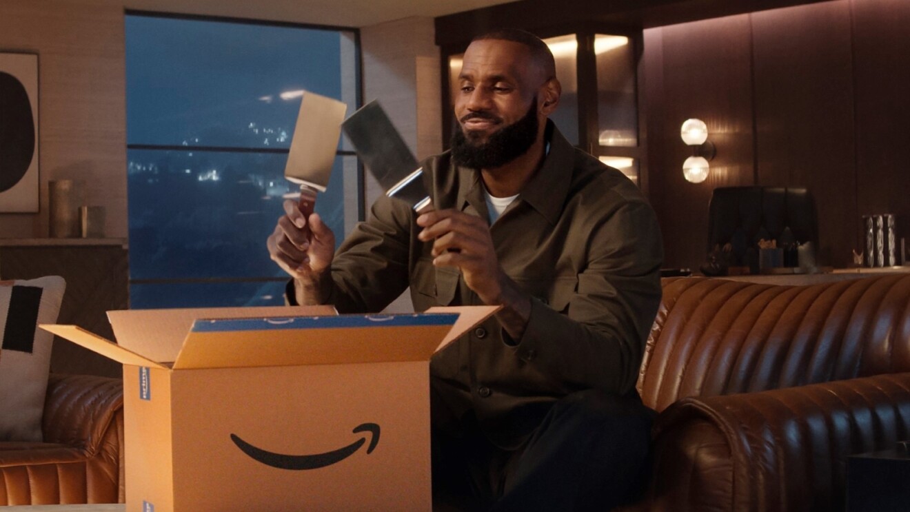 LeBron James holds up two spatulas over open Amazon package