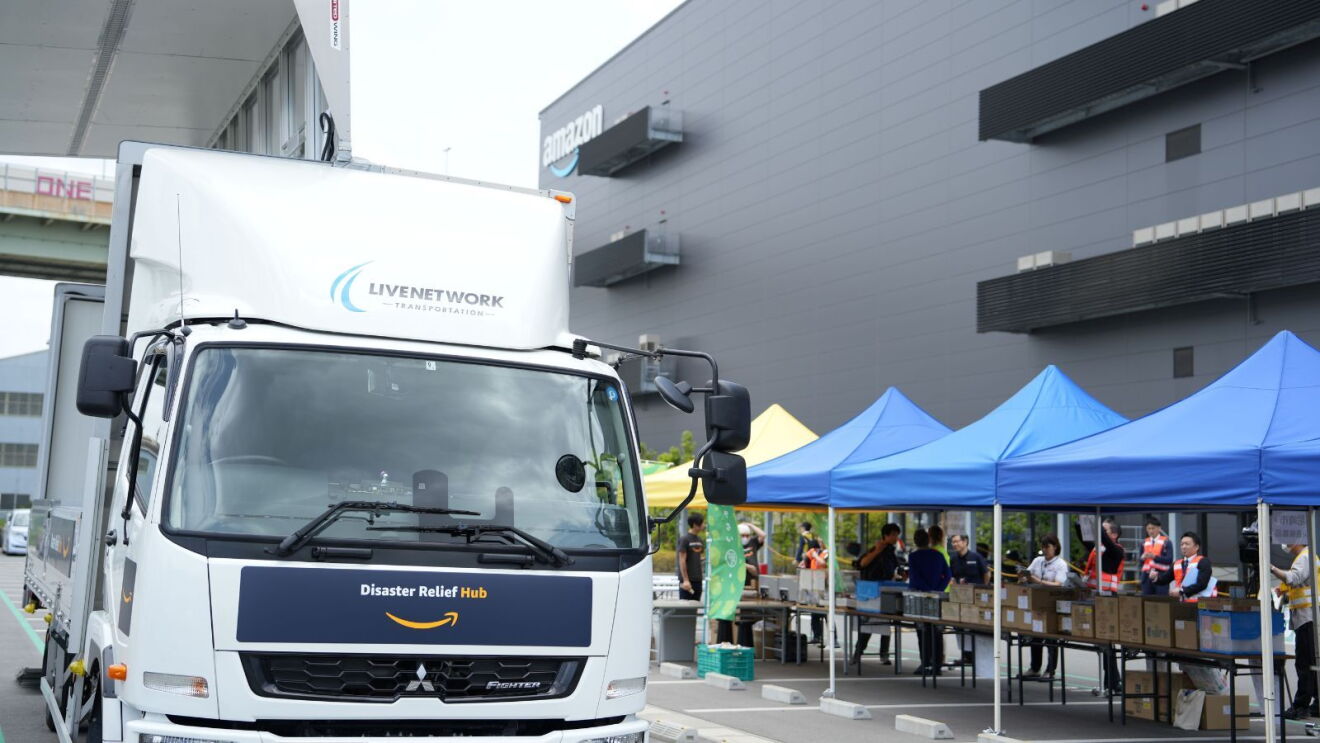 An Amazon Disaster Relief Hub vehicle in Japan leaving the premises with supplies.