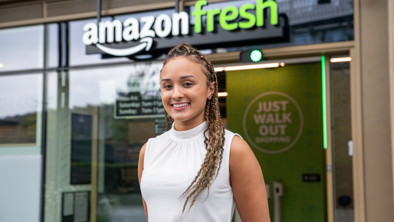 Picture of girl in front of Amazon Fresh store