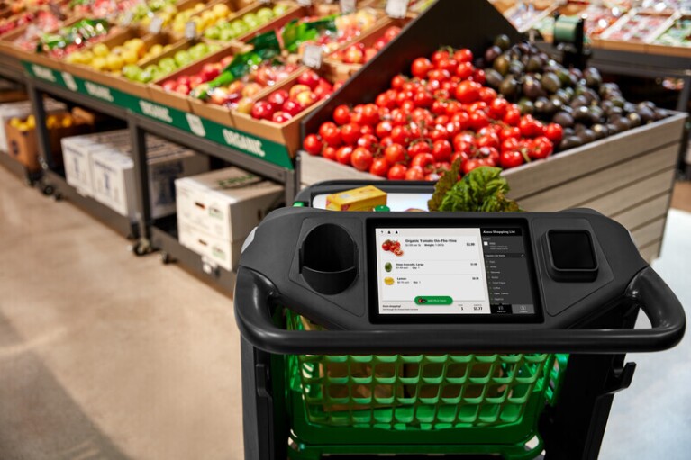 An image of the Amazon Dash Cart in front of produce at an Amazon retail store.