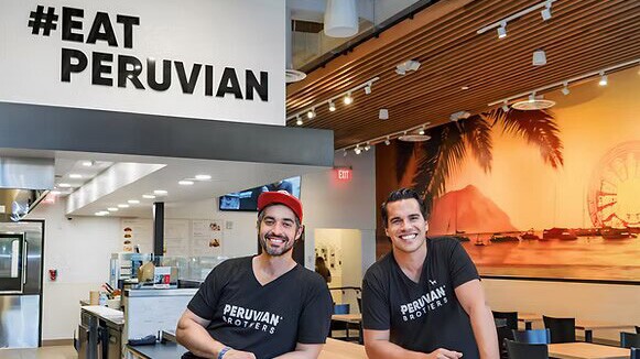 #eatperuvian sin behind two men posing