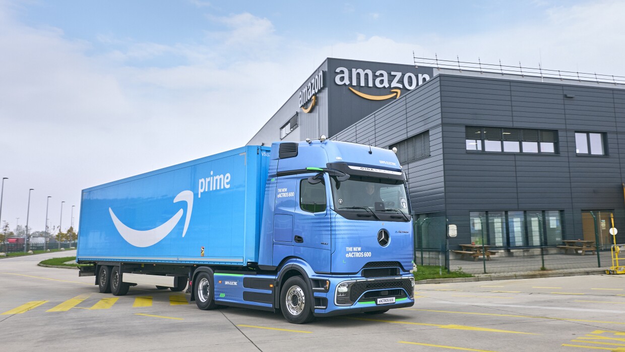 amazon prime truck in front of amazon building