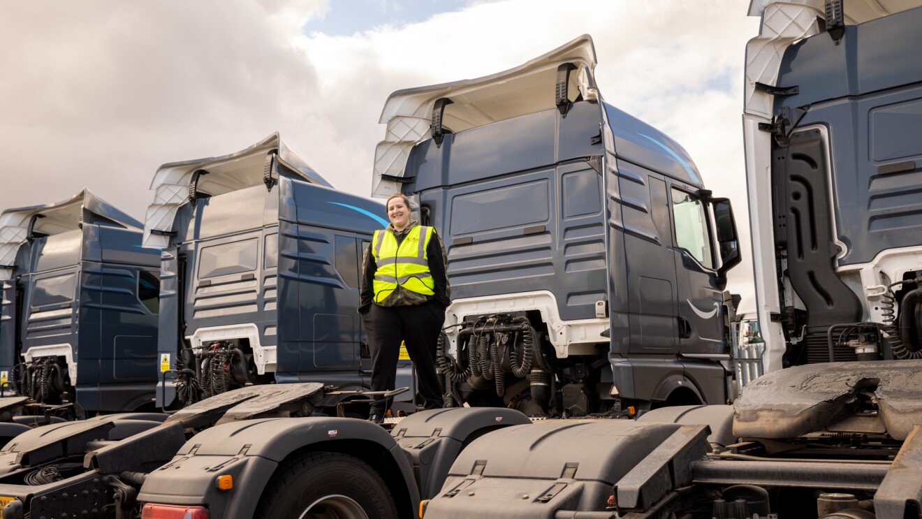 Photograph of Sam standing on delivery trucks