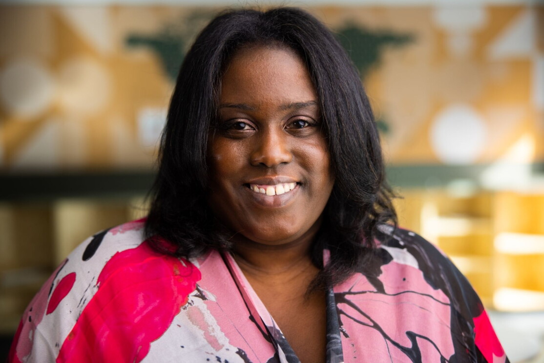 An image of a woman smiling for a headshot photo at the Mary's Place Center in The Regrade.