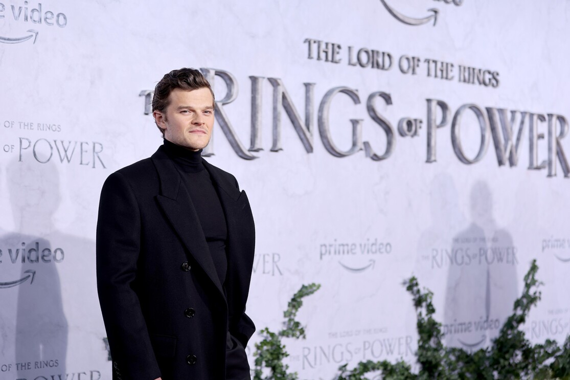 An actor stands for a photo on the red carpet of the premiere for the Lord of the Rings: The Rings of Power
