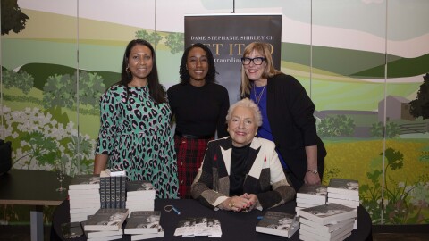 Dame Stephanie Shirley poses with Amazon employees after her speech