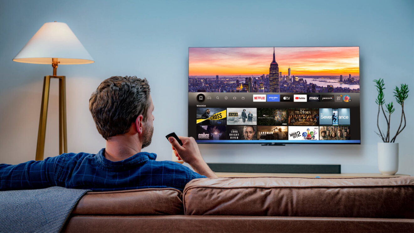 Person watching Fire TV displaying streaming apps and New York City skyline