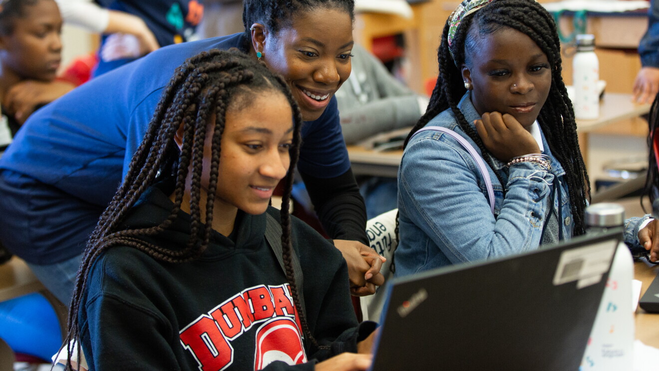 Amazon employee volunteers work on coding projects with students at Dunbar High School in Washington, DC to celebrate Amazon Future Engineer's 2,000 high schools milestone.