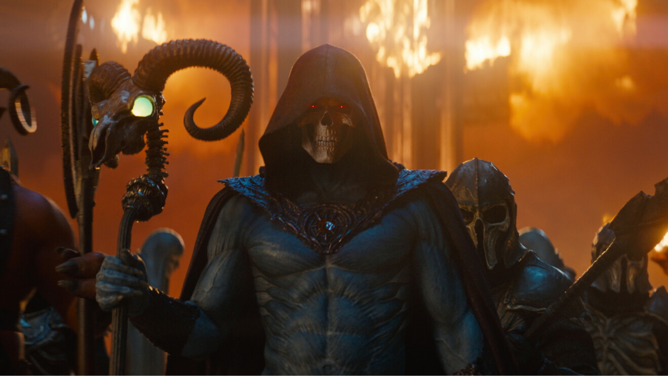 Jared Leto as Skeletor holding a staff.