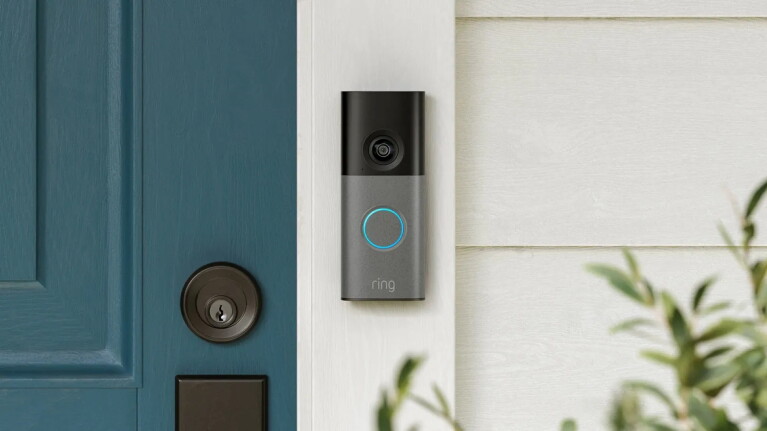 Ring 4K video doorbell mounted next to teal front door