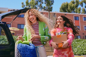 Colorfully dressed friends arriving on campus with deliveries and purchases