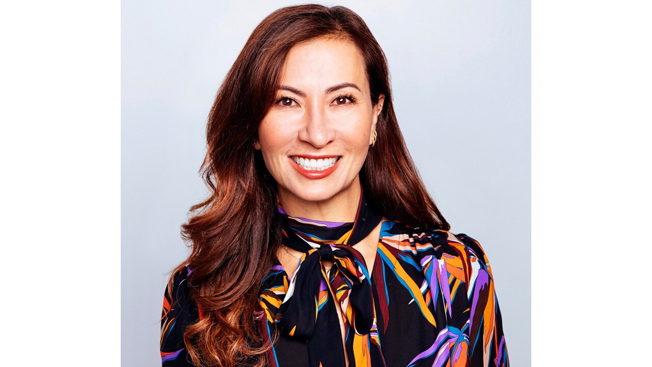 A headshot image of a woman against a white background.