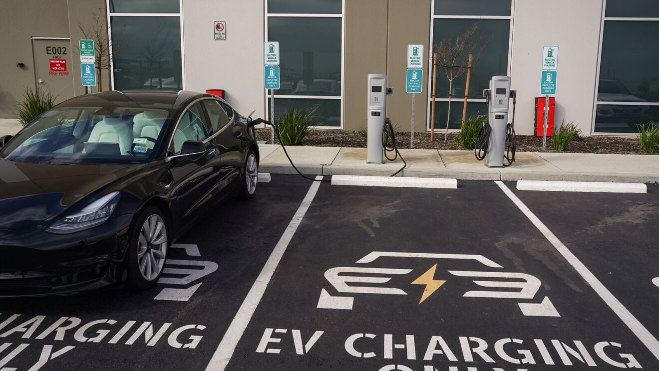 cars at an electric vehicle charging station
