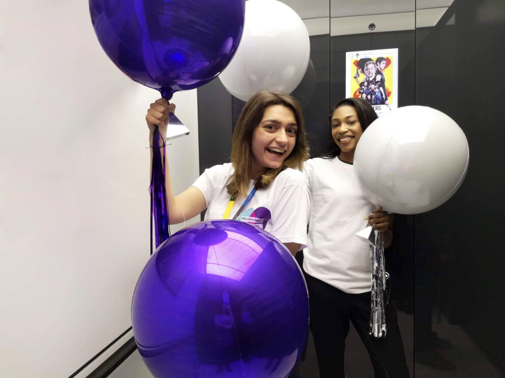 Amazon employees holding balloons for International women's day