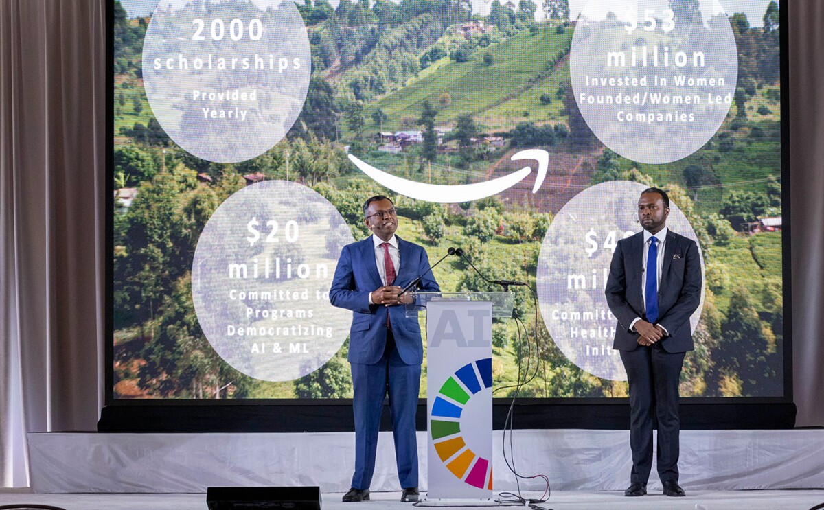 A photo of AWS Vice President Swami Sivasubramanian and Dr. Kingsley Ndoh, founder of Hurone AI, speaking on stage at the UN AI Summit in New York City.