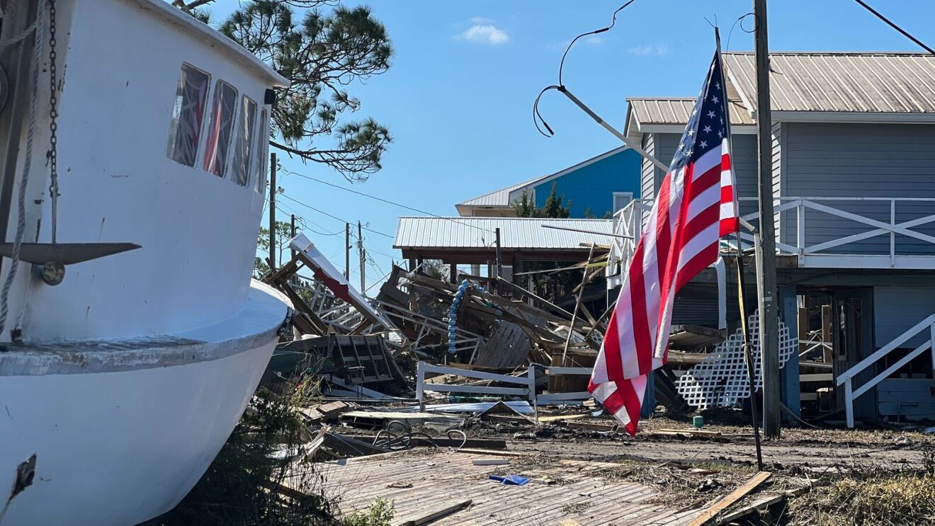 Hurricane Helene disaster. Building destroyed. American flag on the right.
