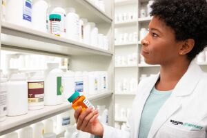 Female pharmacist checking medicine inventory