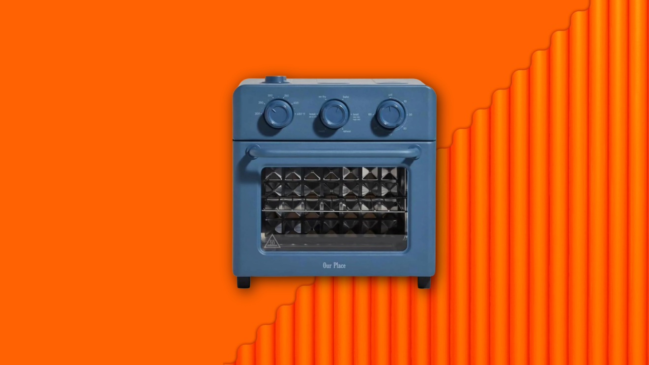 A blue Our Place air fryer and toaster oven floating against a vibrant orange background.