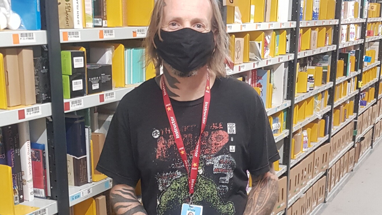 Graeme Ferry, Associate at Amazon's fulfilment centre in Peterborough, pictured standing in one of the aisles.