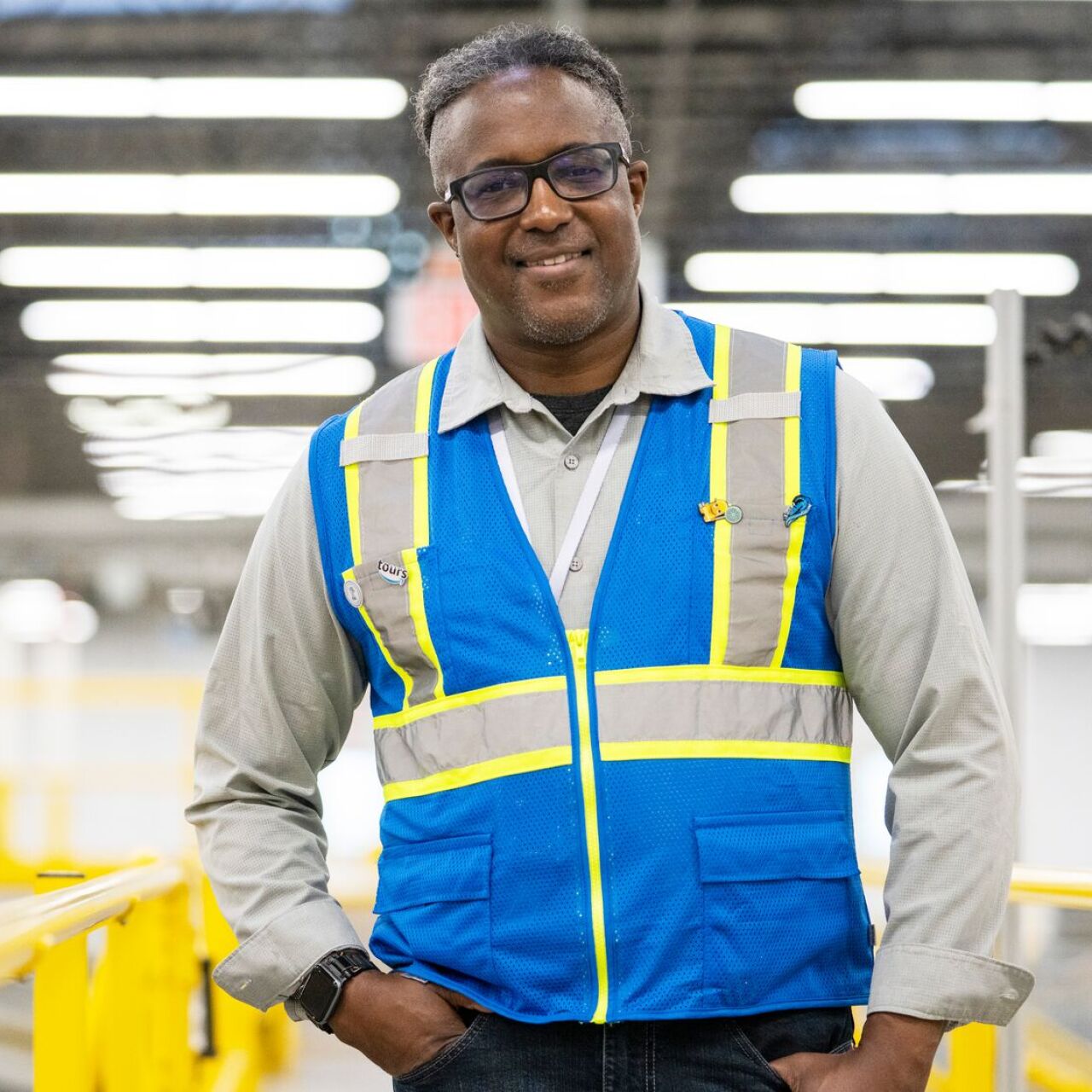 Cedric Ross, Head of Partnerships and VIP Tours North America at Amazon, smiles in fulfillment center.