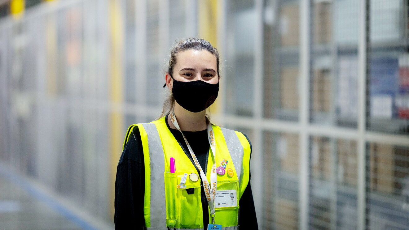 Natalie Emmerman, Area Manager at Amazon's fulfilment centre in Tilbury, pictured wearing a high visibility vest and a face mask.