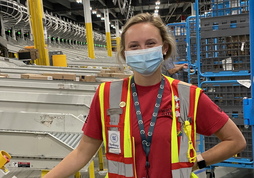 An Amazon employee smiles at the camera