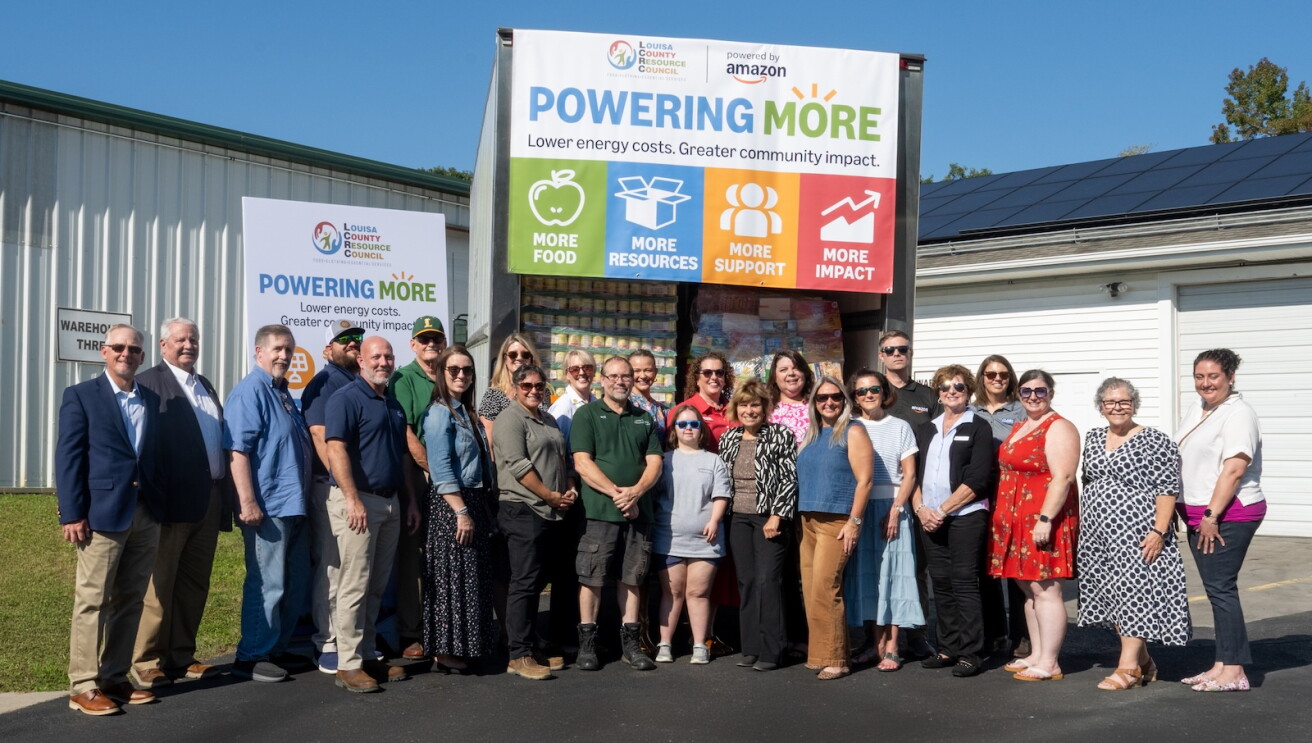 A group gathers beside a truck loaded with goods from the Louisa County Resource Council in Louisa County, Virginia.