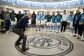 Pep Guardiola stands in the Man City dressing room, giving his players a team talk 