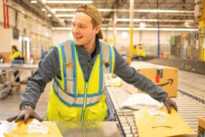 An Amazon operation employee works in a fulfillment center.