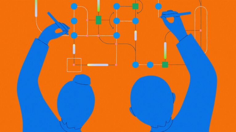 Two people with raised arms arranging connected nodes and shapes on a digital flowchart