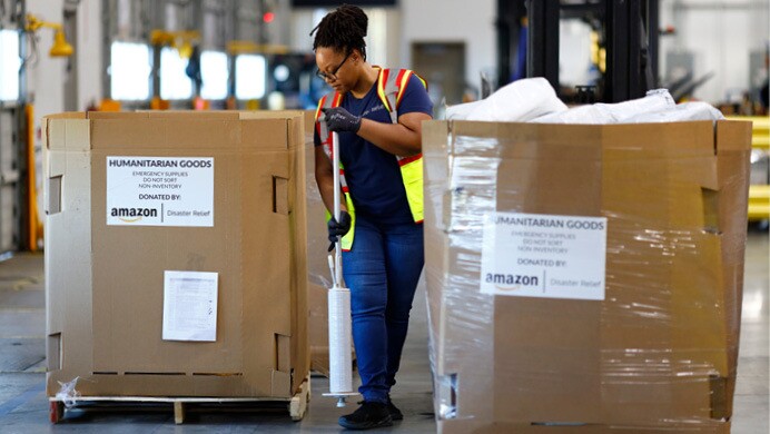 A volunteer helps pack donated supplies at an Amazon fulfillment center to support Hurricane Ian relief