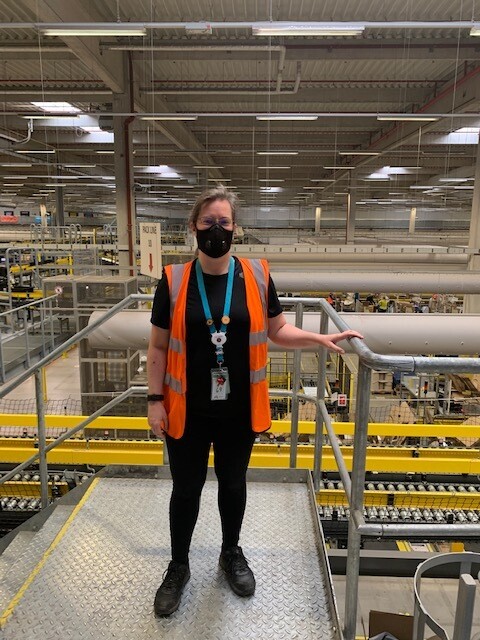 Morag Kitson, Associate at Amazon's fulfilment centre in Swansea, pictures standing on a mezzanine overlooking the shop-floor.