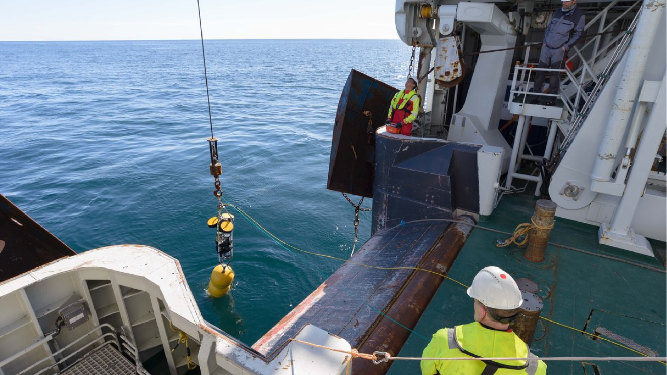 Boat at the LoVe Observatory in Norway, team collecting data and bringing up the underwater sensors.